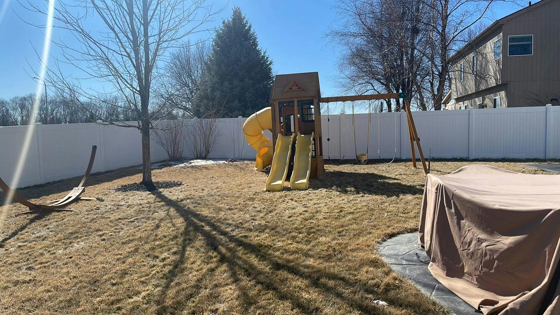 Backyard with a swing set and slides