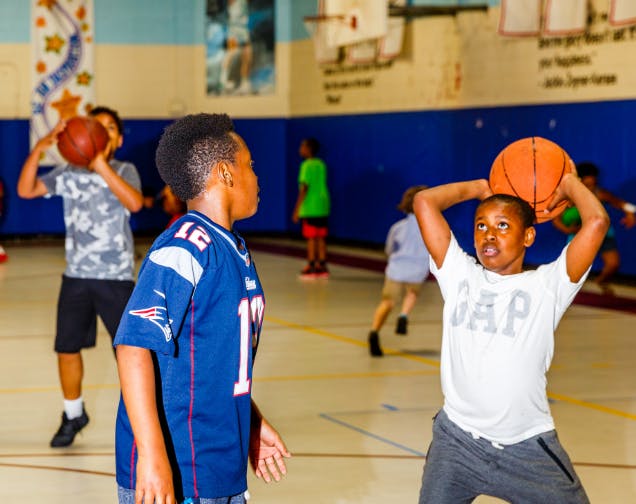 Children playing basketball in a gym