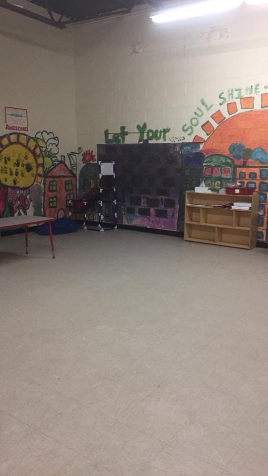 Classroom with colorful wall murals and furniture