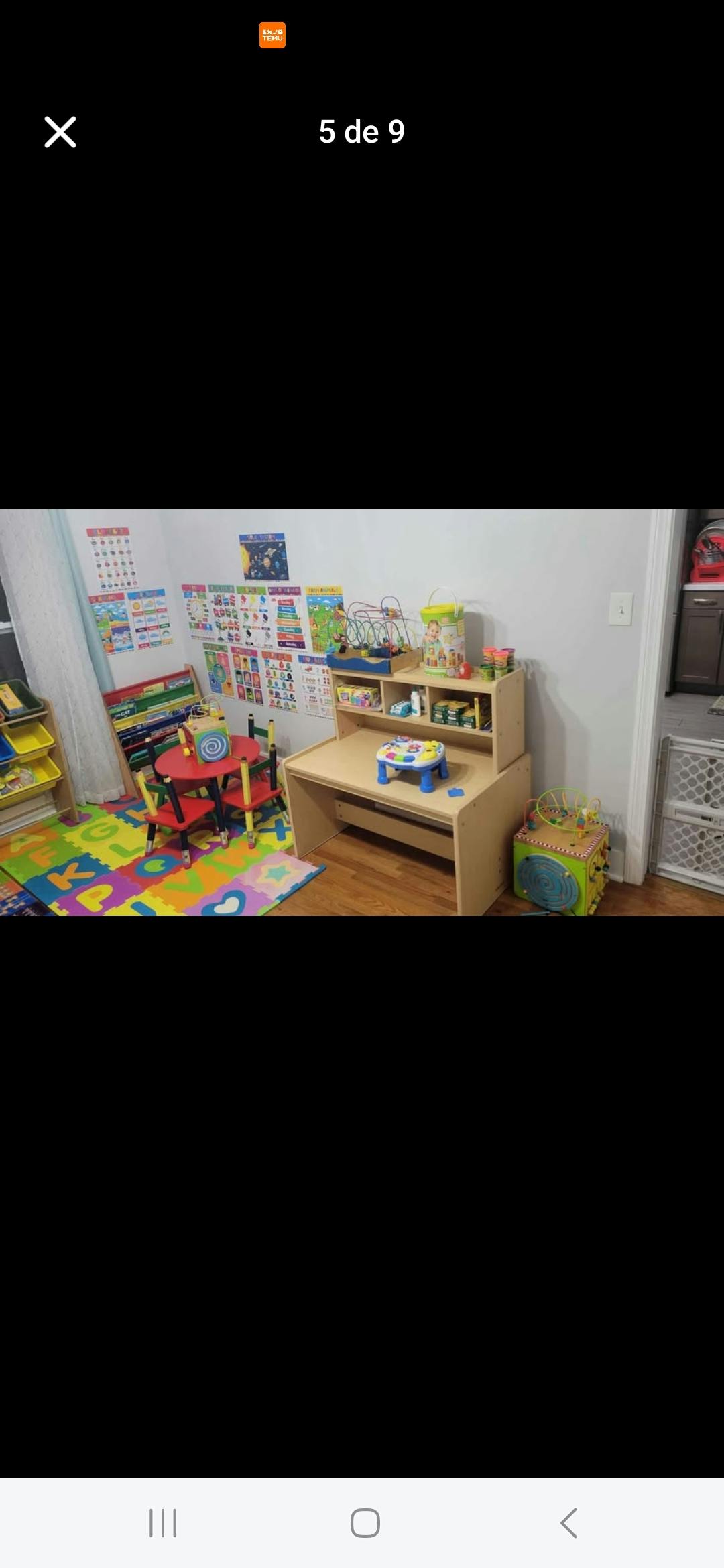 Child's play area with a small desk, chairs, and colorful floor mats
