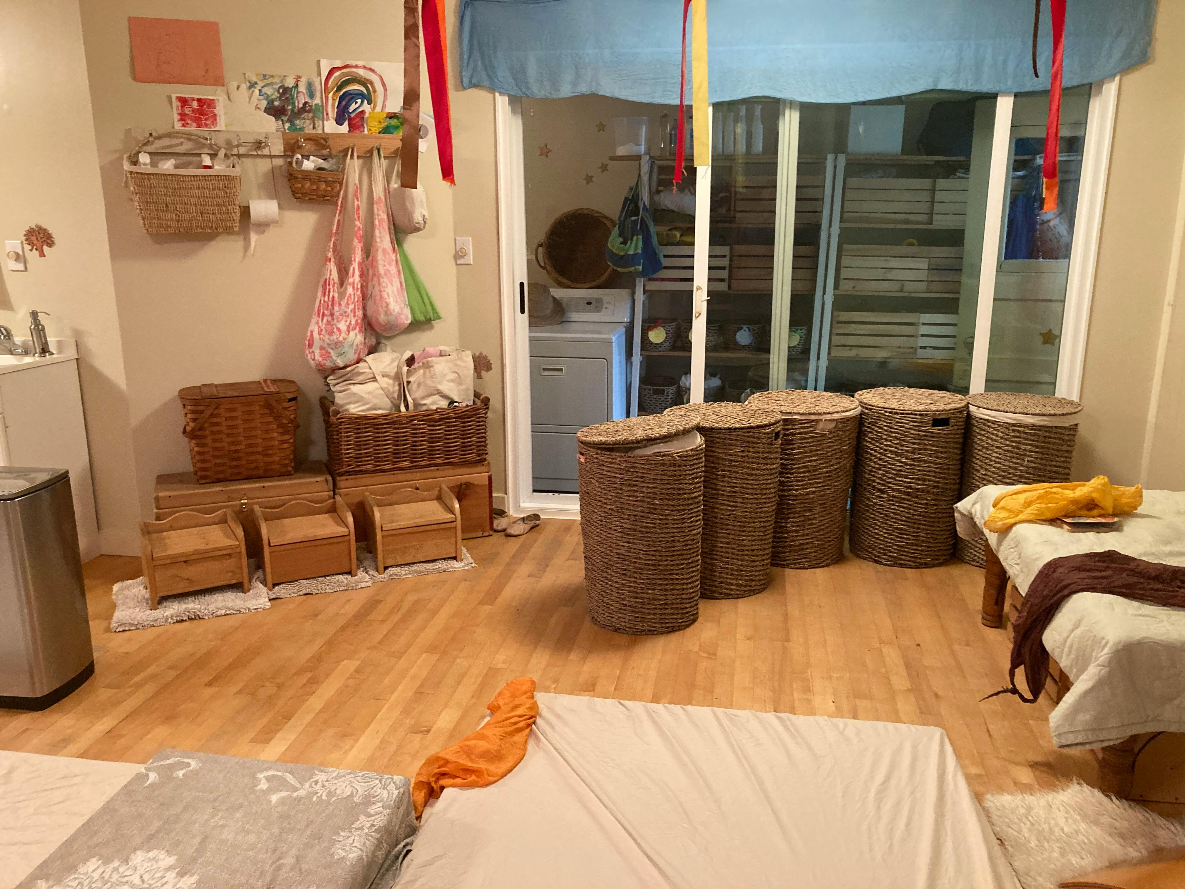 Room with baskets, wooden stools, and a sliding glass door