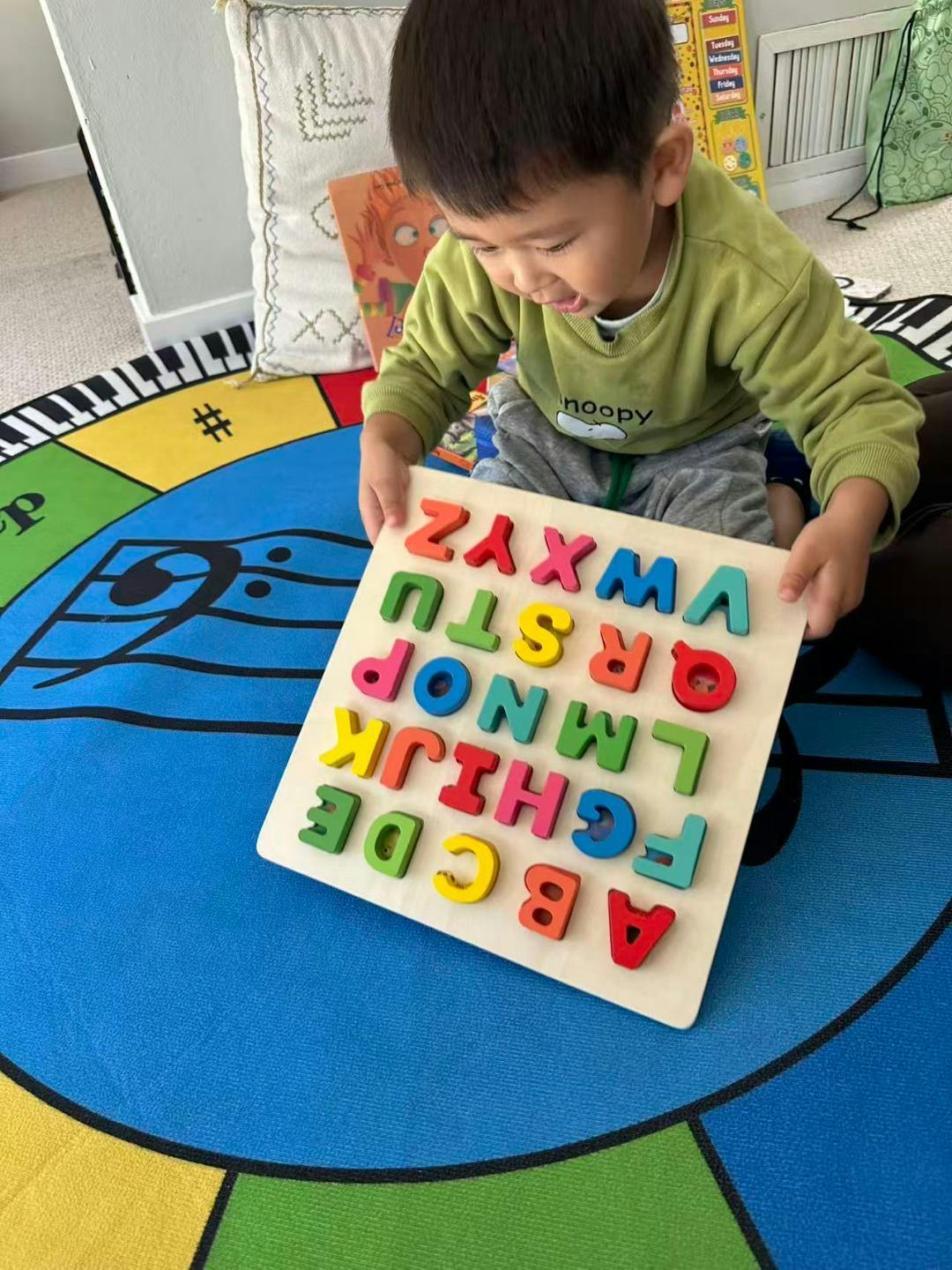 Child playing with an alphabet letter puzzle
