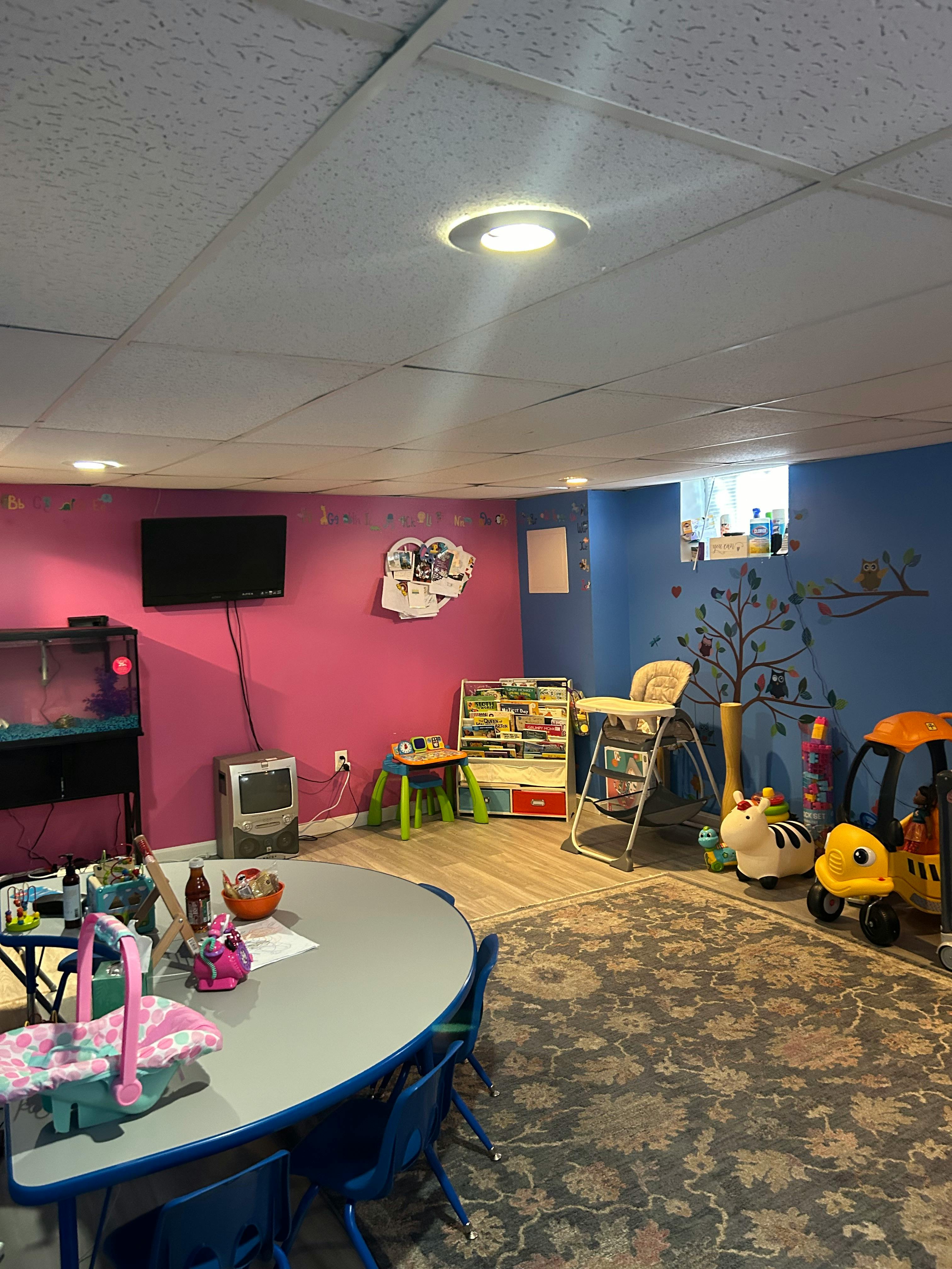 Playroom with a table, chairs, toys, and a television