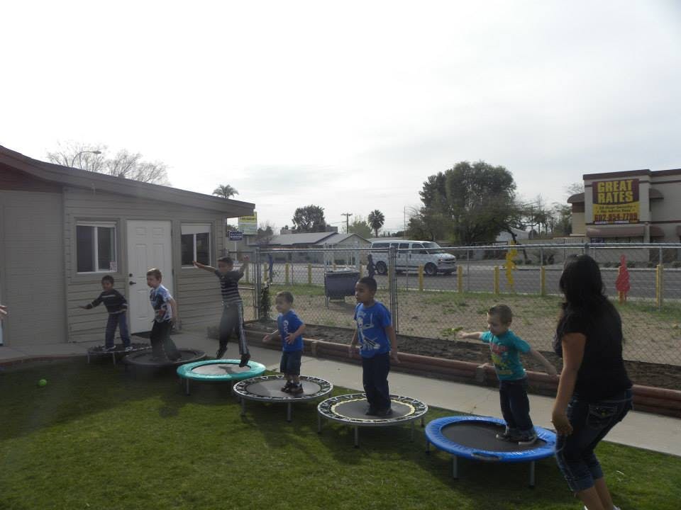 Children jumping on trampolines outdoors