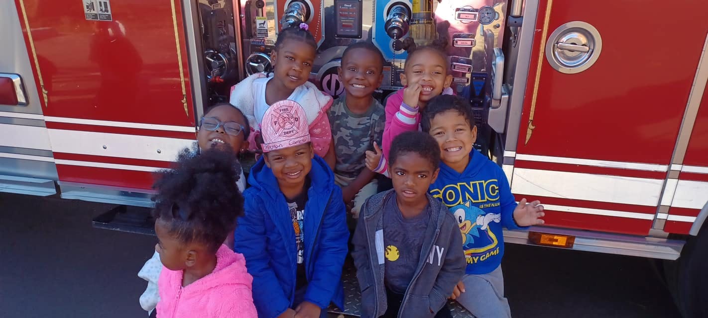 Group of children in front of a fire truck