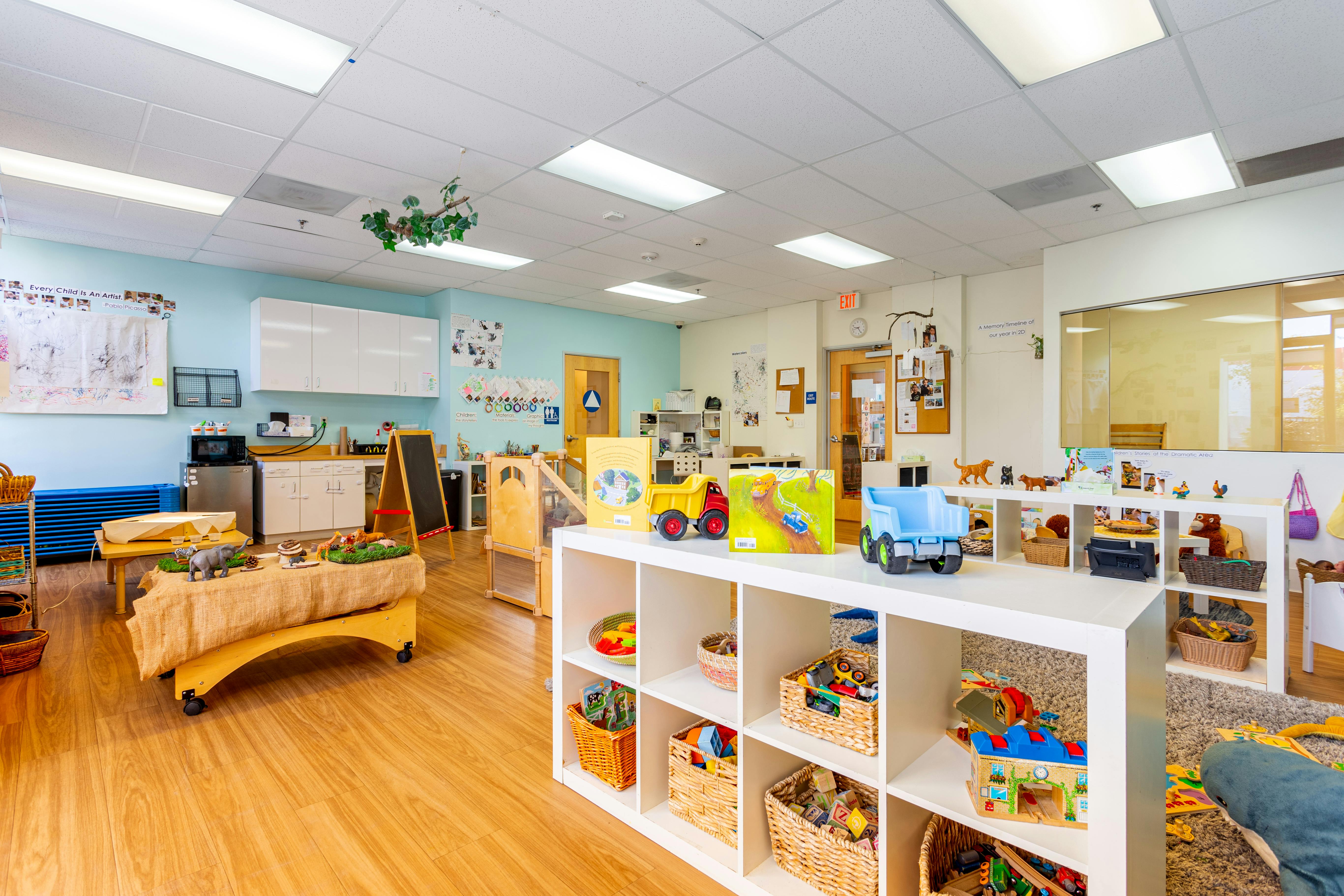 Playroom with shelves of toys and a wooden play table