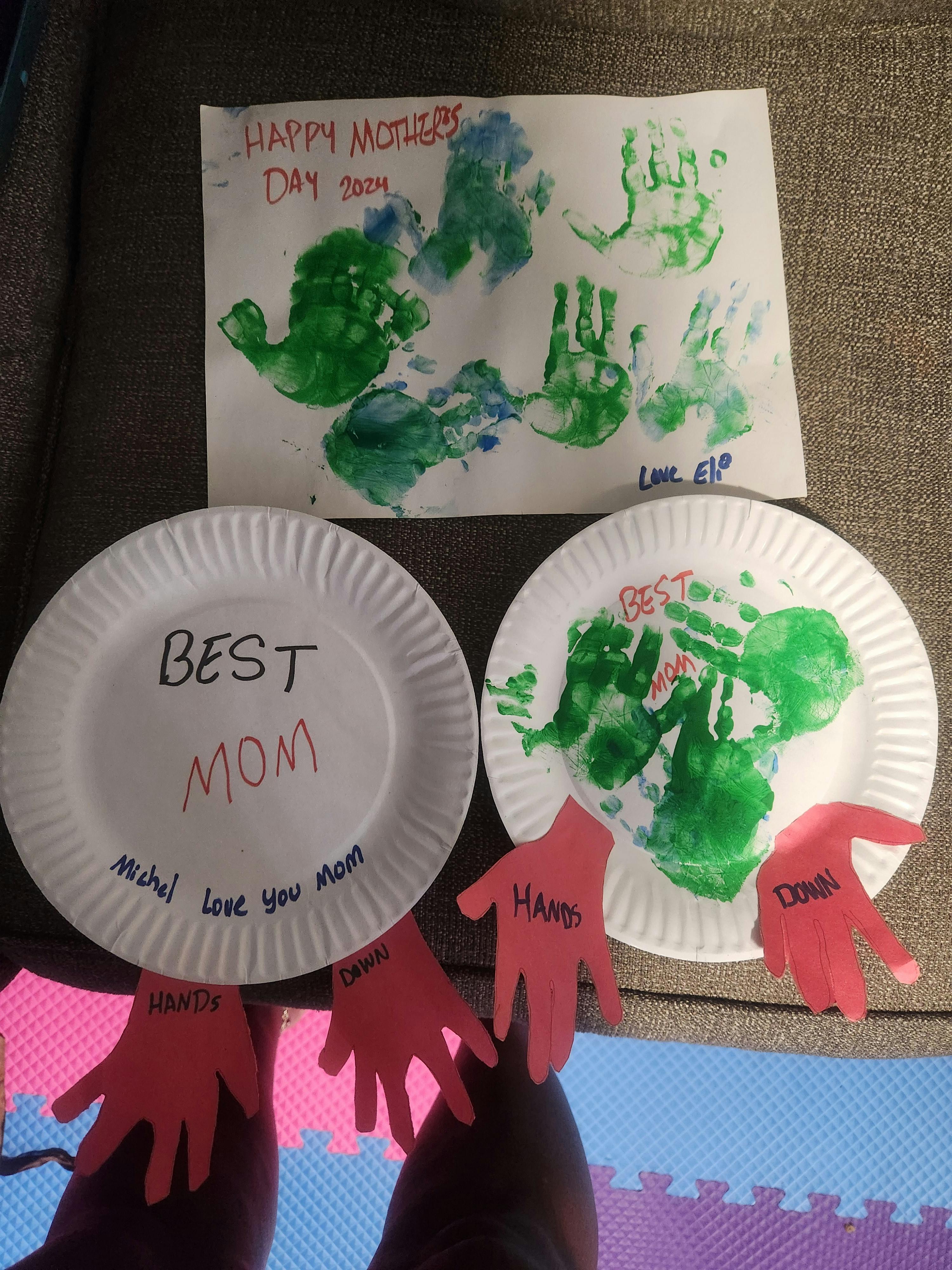 Children's artwork with handprints and text "Happy Mother's Day" and "Best Mom"