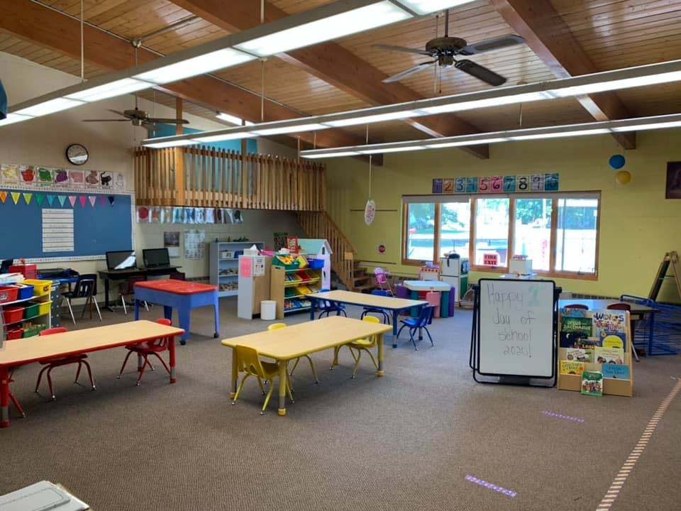 Empty classroom with small tables and chairs