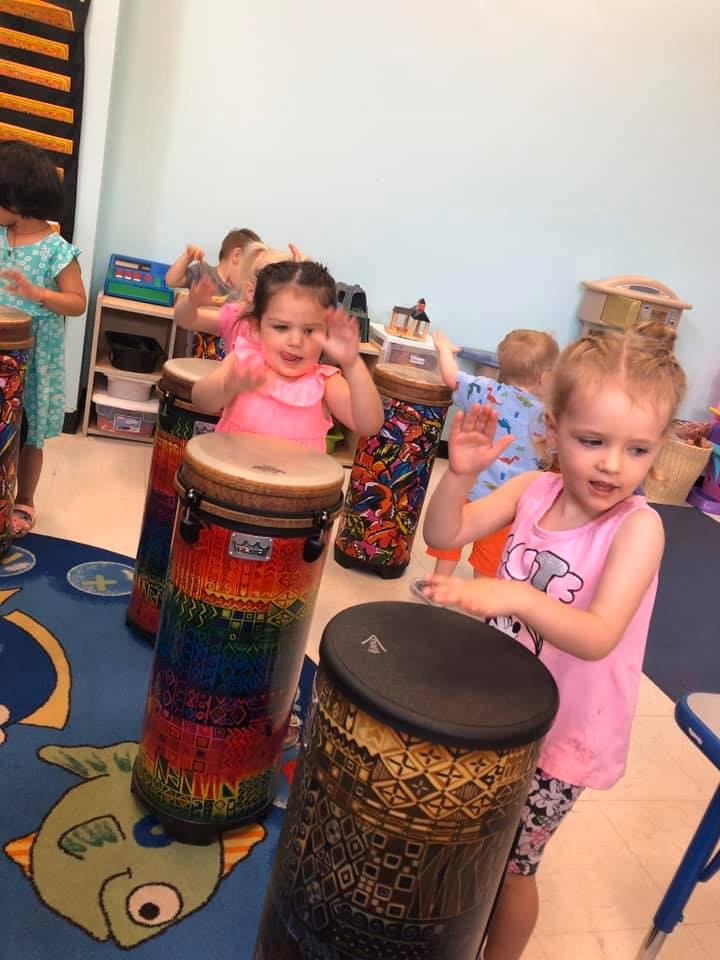 Children playing drums in a classroom