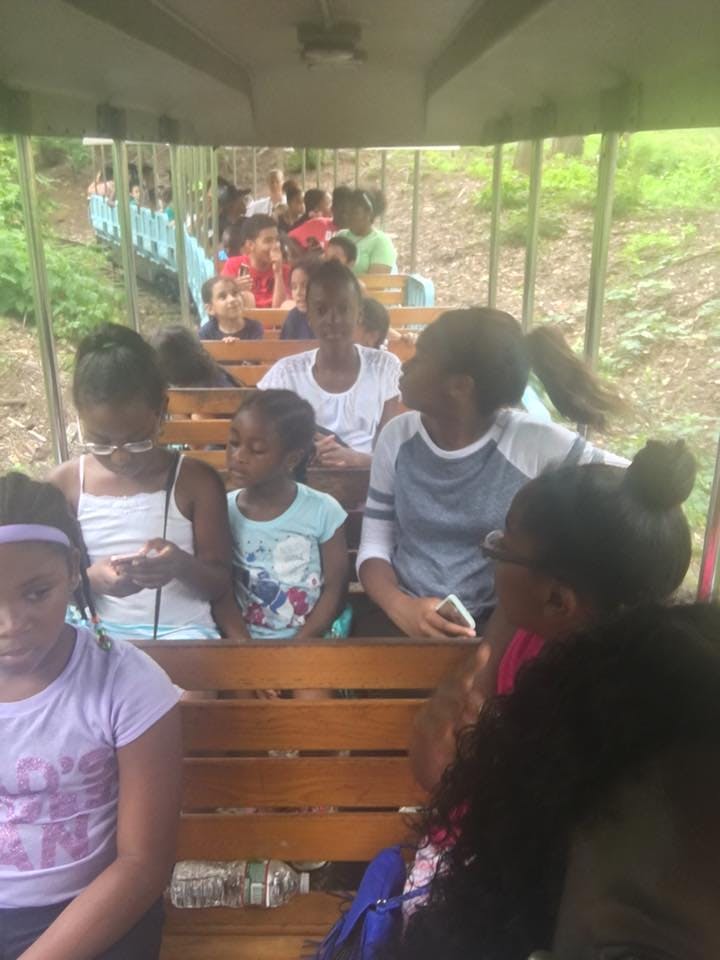 Children and teens riding in a train car