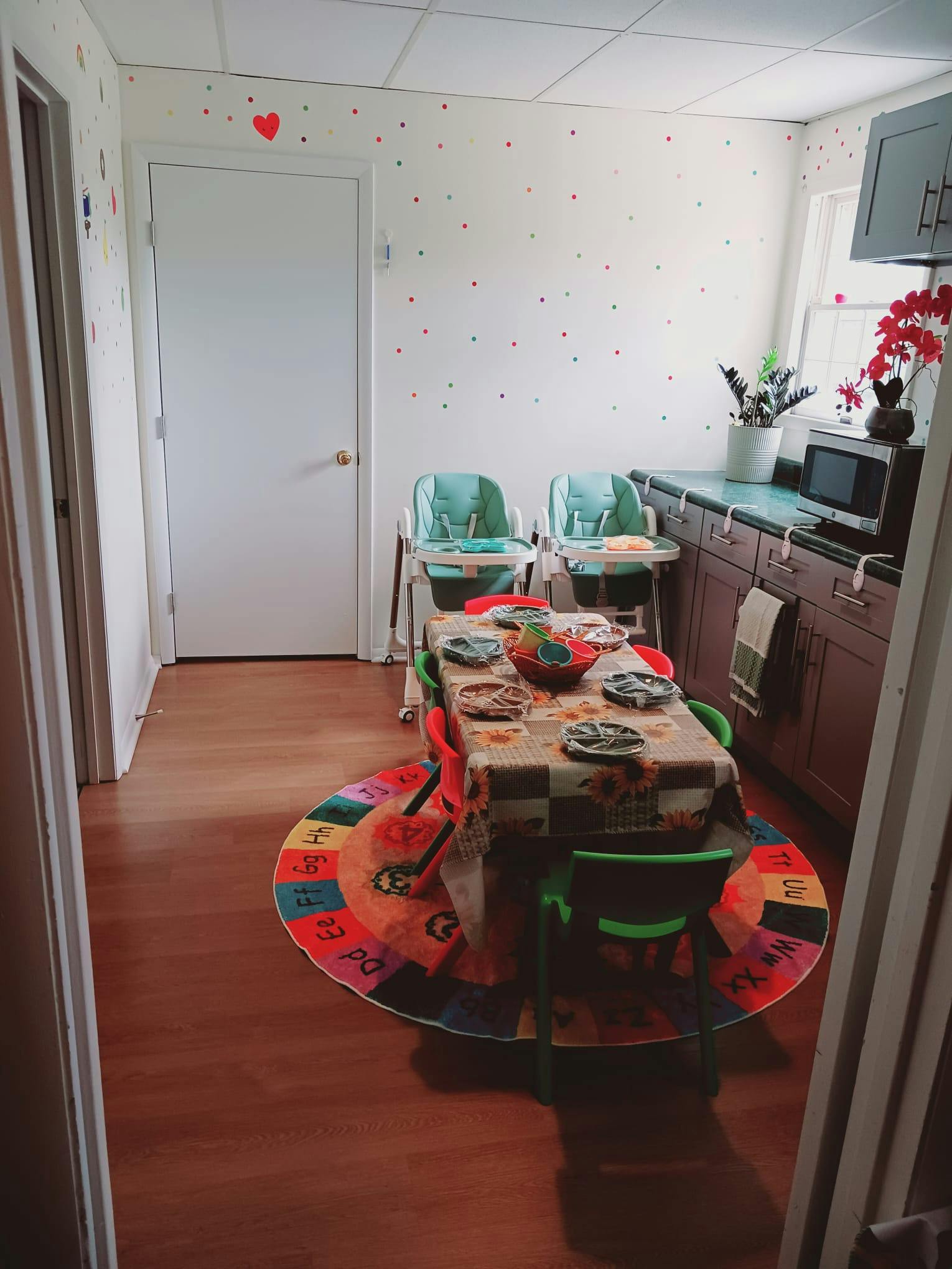 Dining area with a table set for children and two high chairs