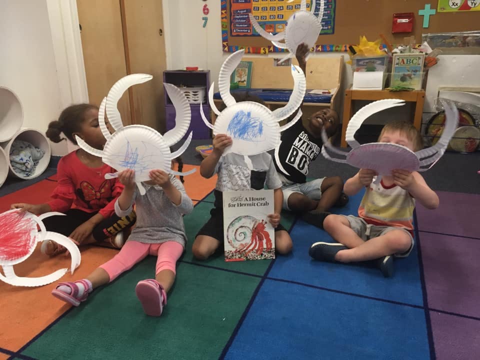 Children wearing paper plate crab hats