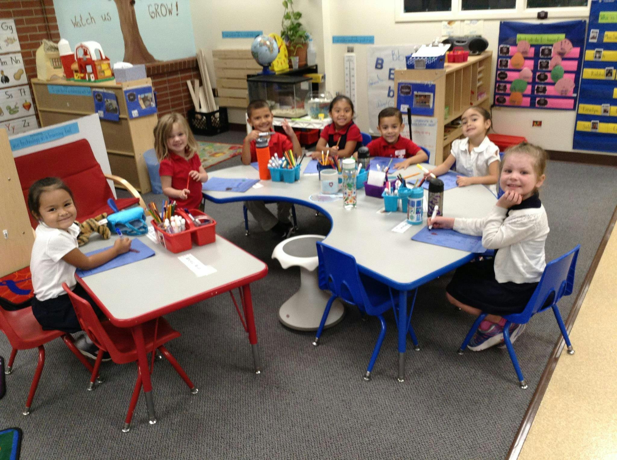 Children sitting at tables in a classroom
