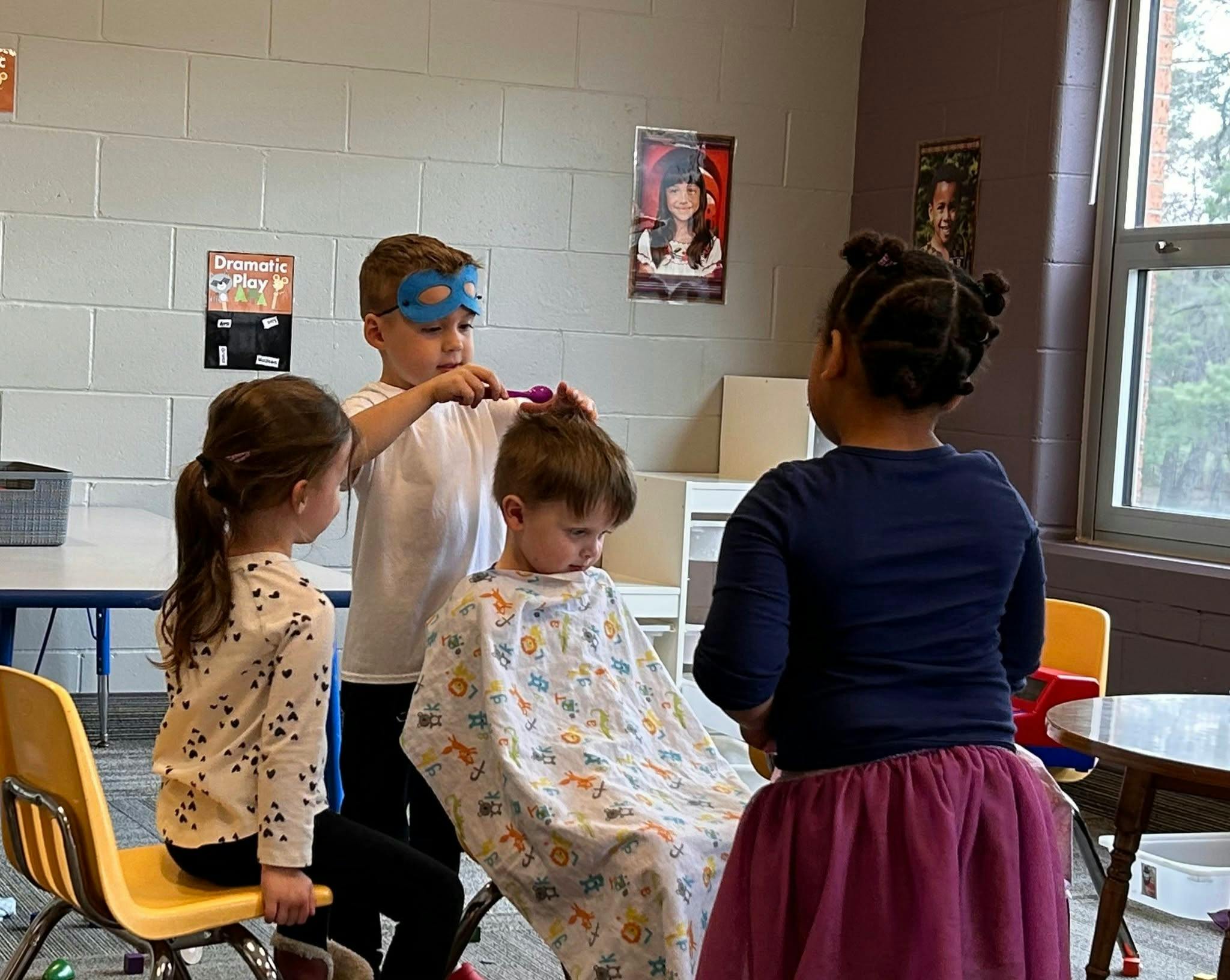 Child in mask pretending to cut another child's hair with a comb