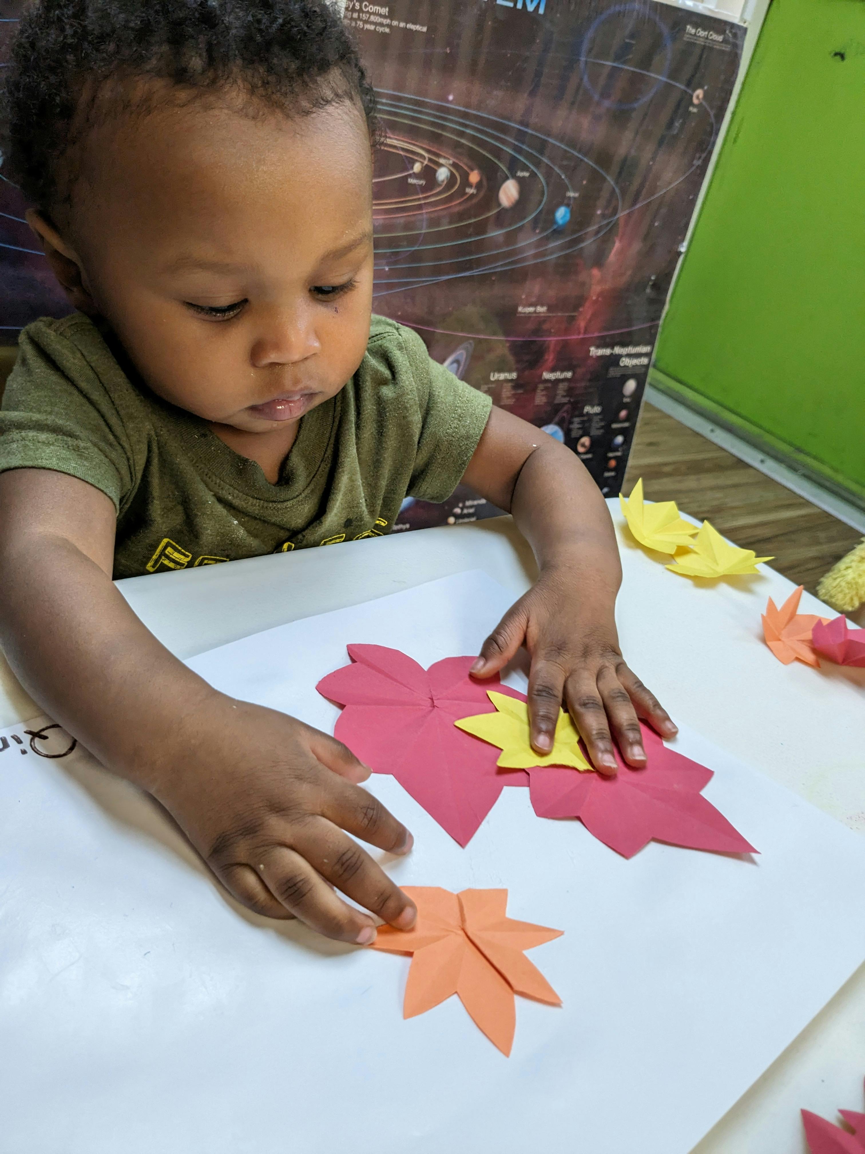 Child playing with paper cutouts