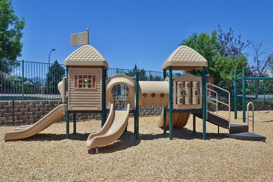 Playground structure with slides, tunnels, and climbing elements