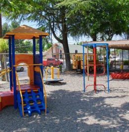 Playground with colorful play structure, slide, and monkey bars