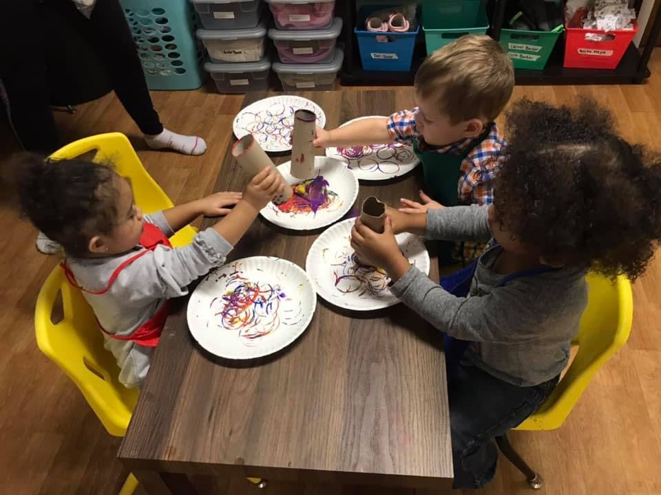 Three children doing crafts at a table