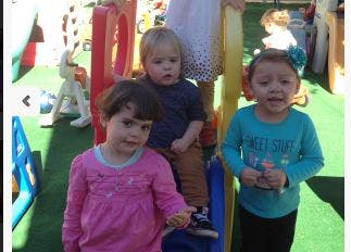 Three children on a playground structure