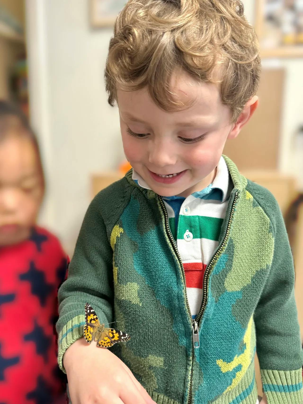 Child with a butterfly on their hand