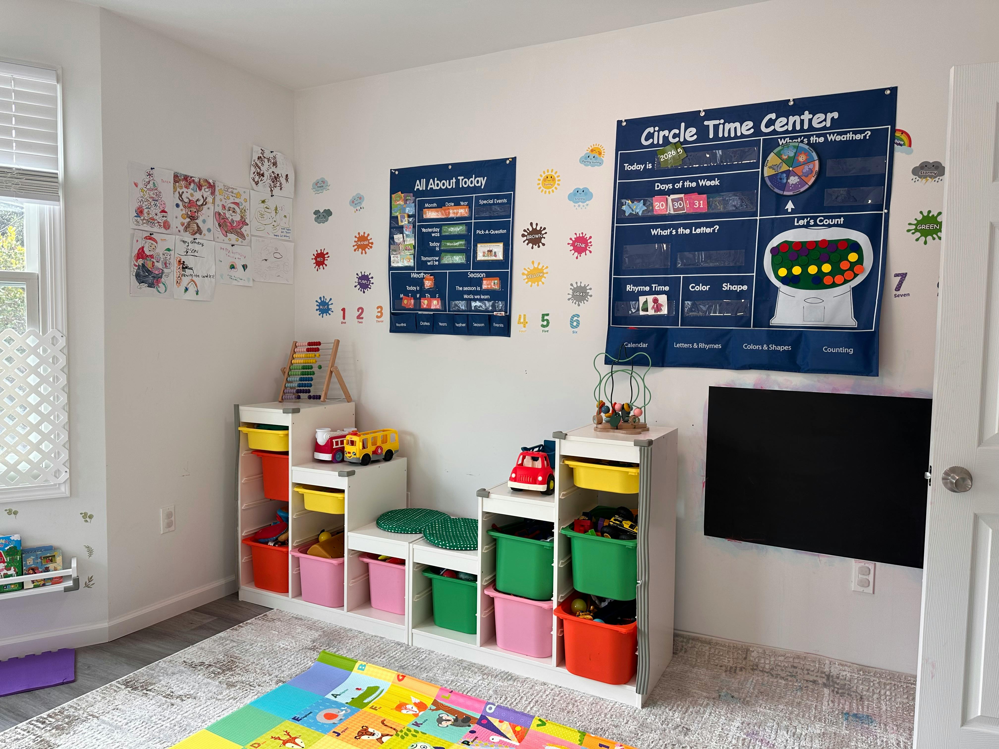 Playroom with toy storage shelves and educational posters on the wall
