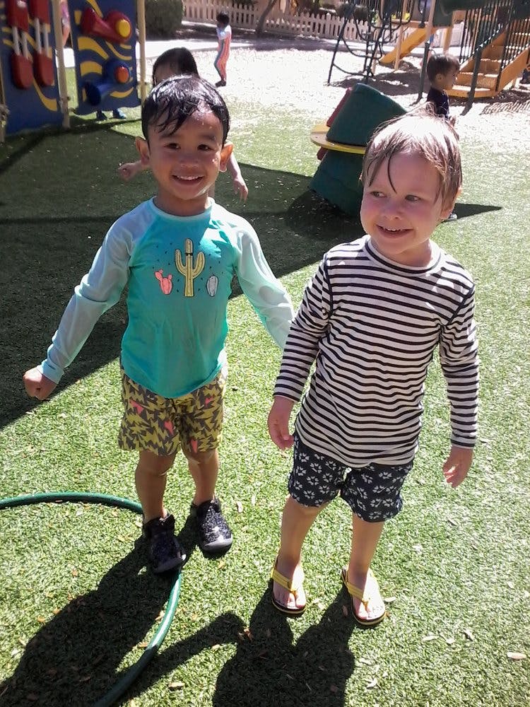 Two children standing on grass