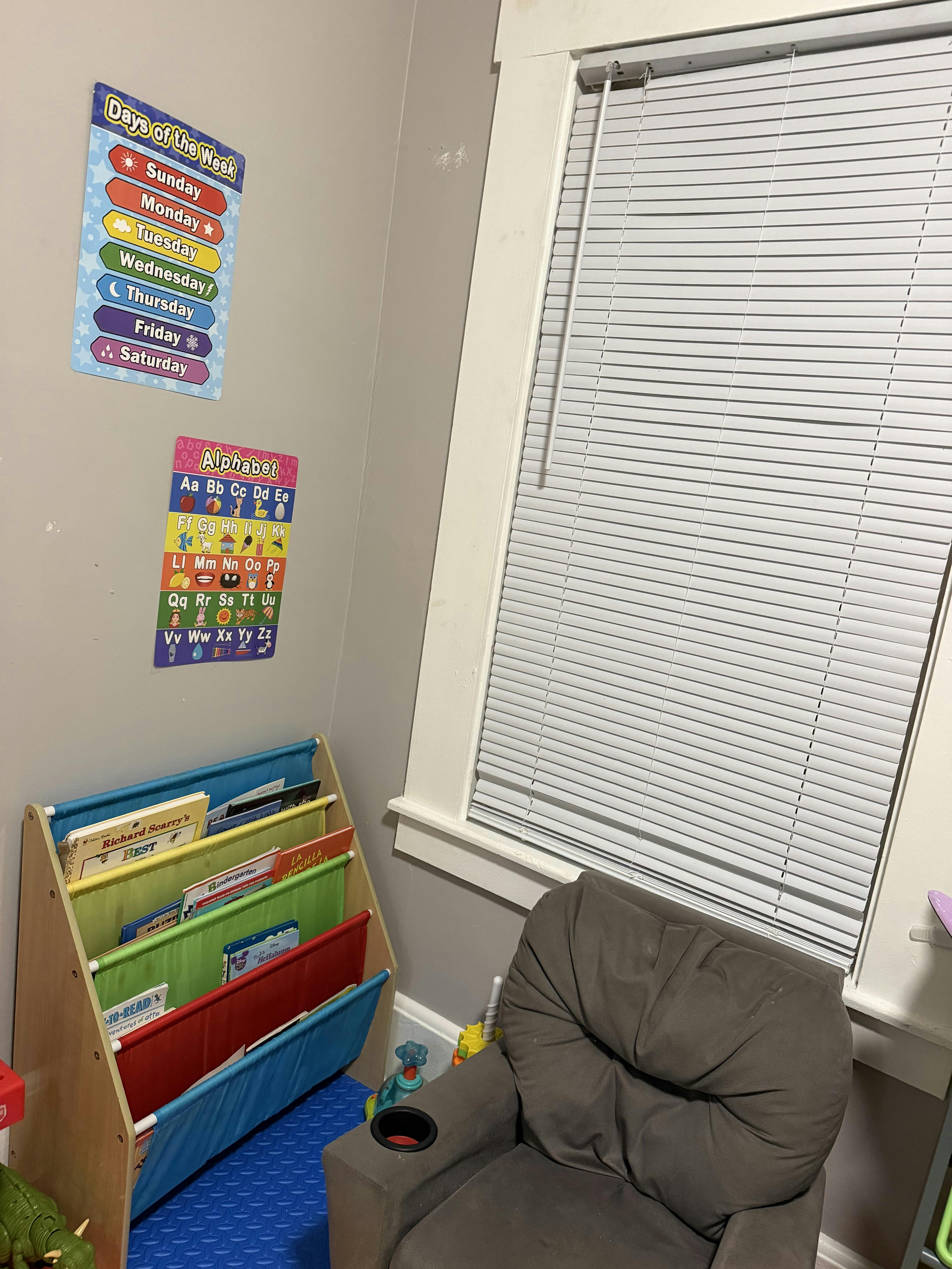 Childs reading corner with alphabet and days of the week charts
