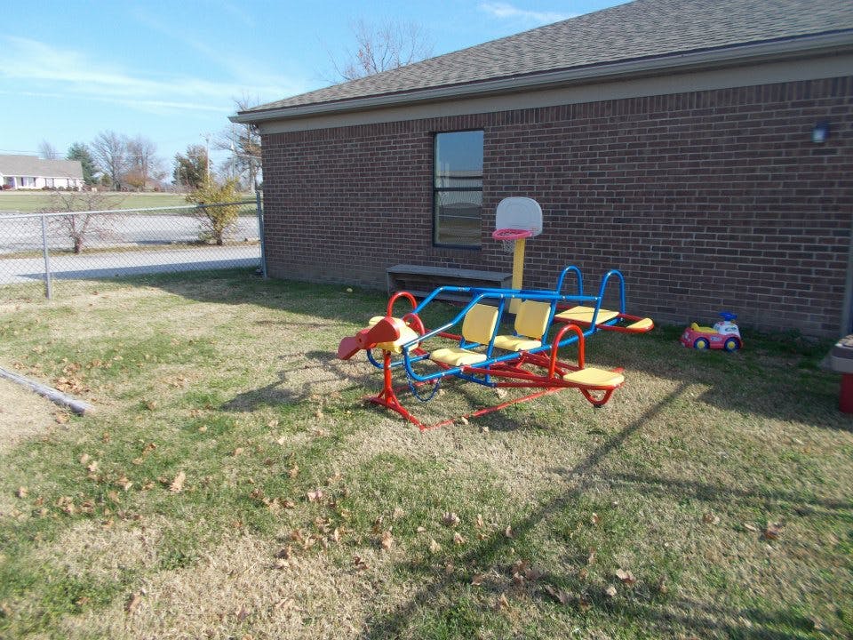 Playground equipment with a seesaw and basketball hoop