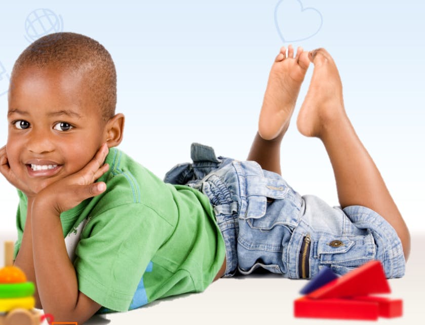 Child lying on stomach with head propped on hands