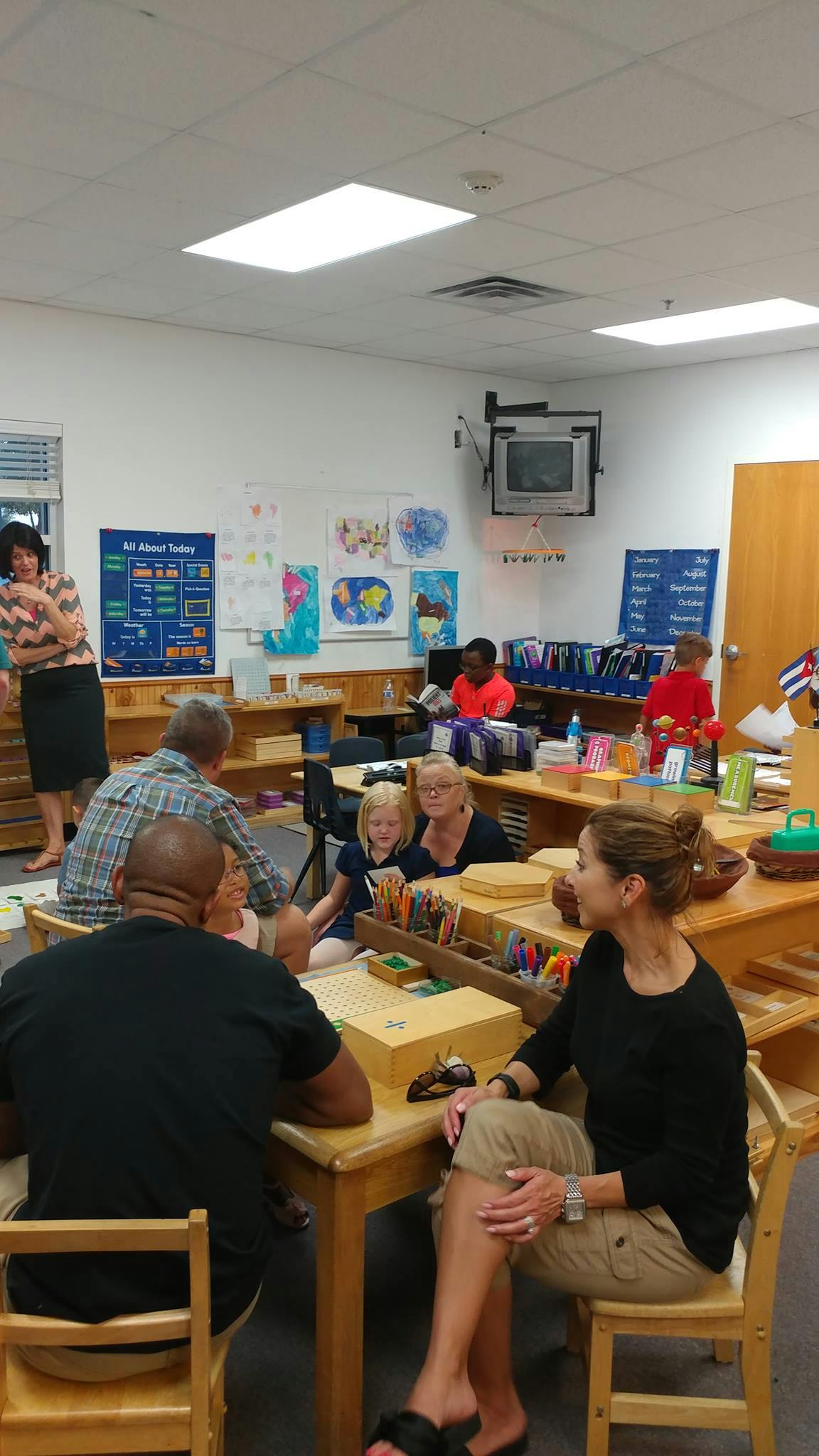 People and children in a classroom