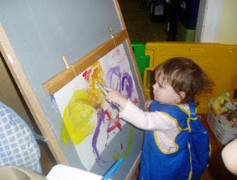 Child painting on an easel
