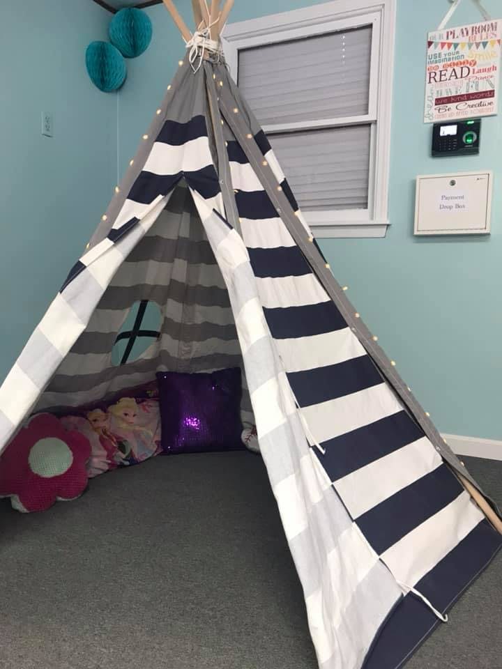Striped play tent with pillows inside