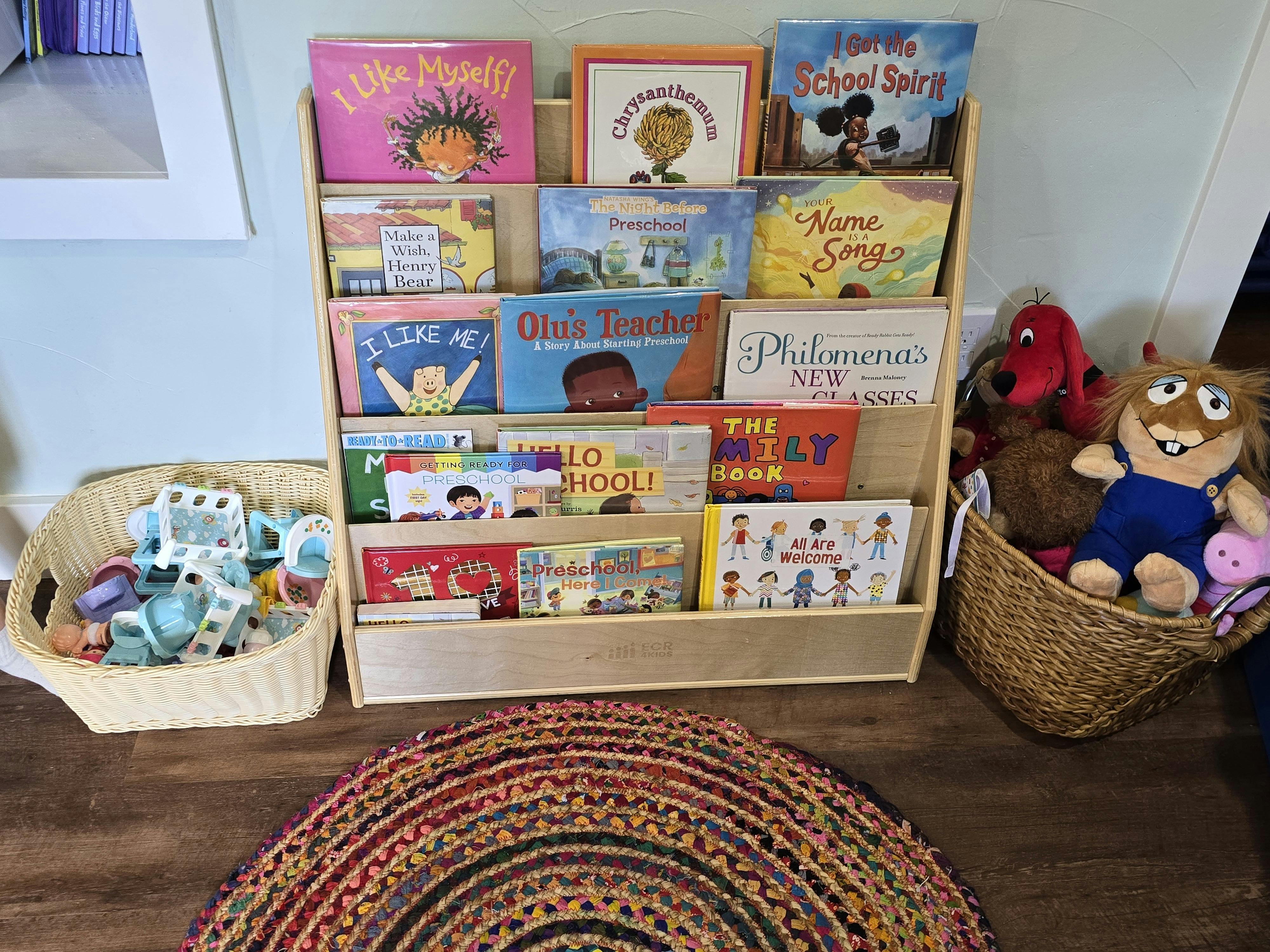 Bookshelf with children's books, a basket of toys, and a basket of stuffed animals