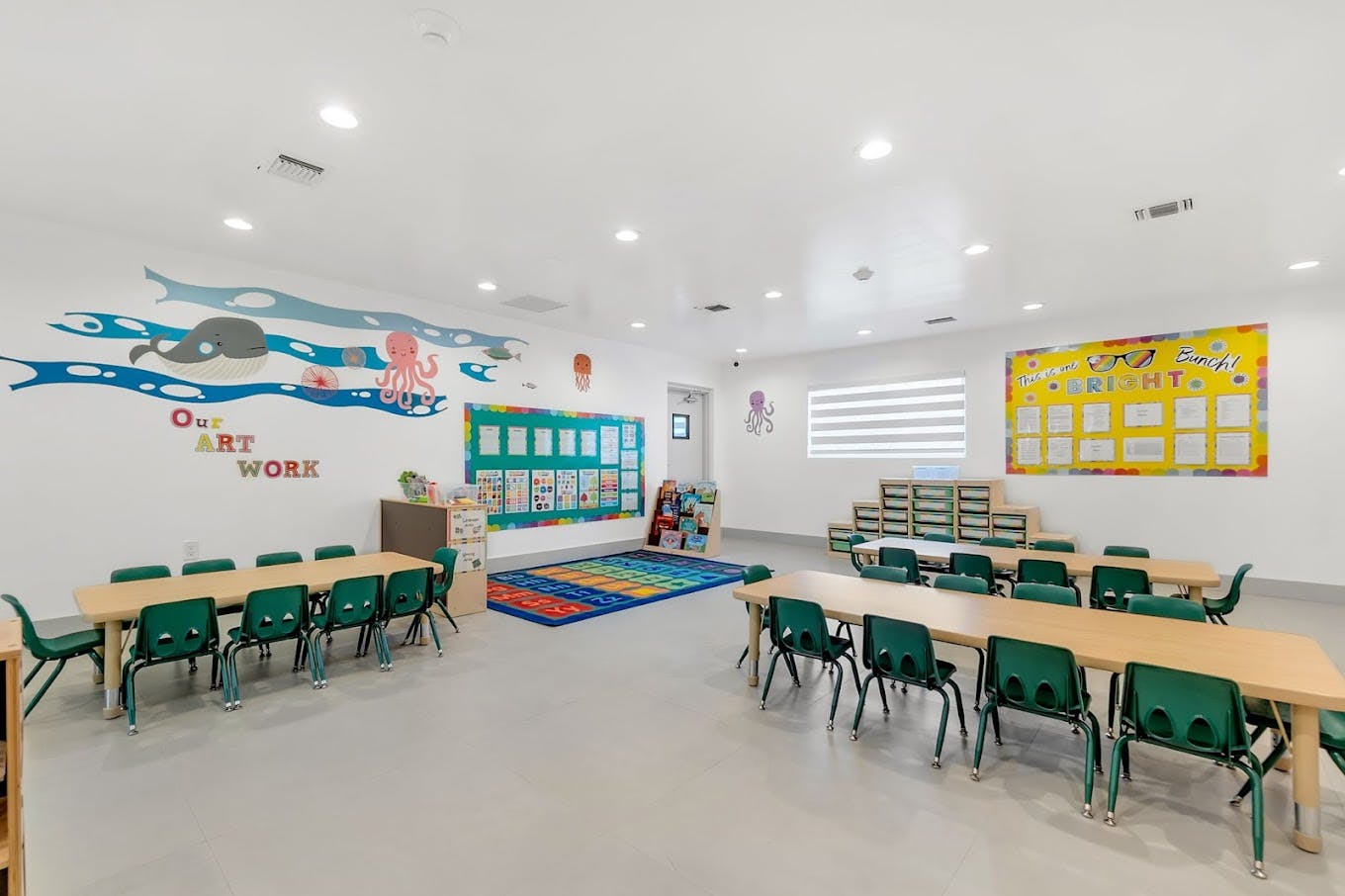 Empty classroom with small tables and chairs