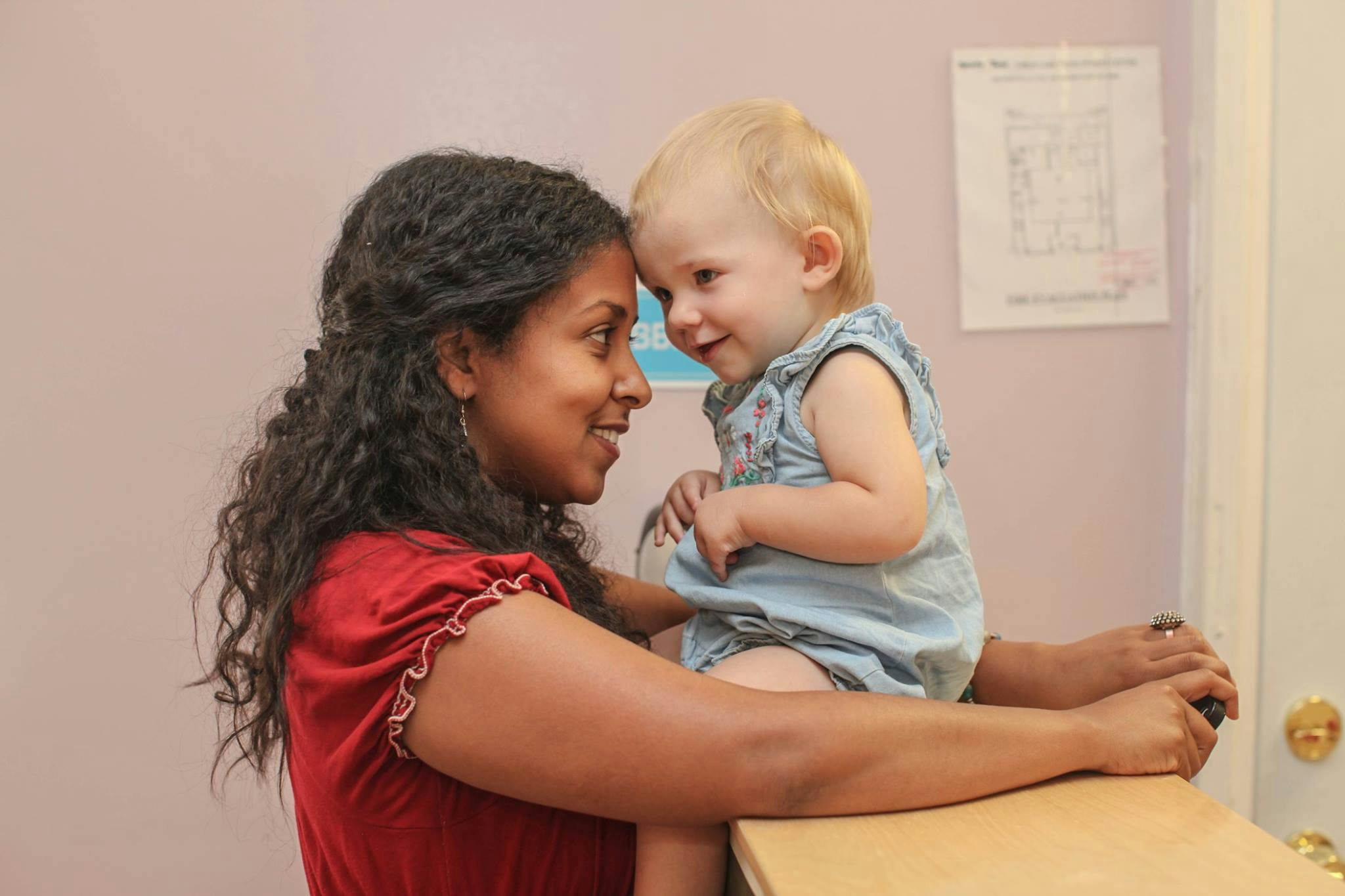 Person and child touching foreheads