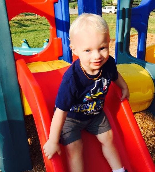 Child on a red slide at a playground