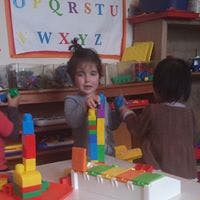 Child playing with colorful building blocks