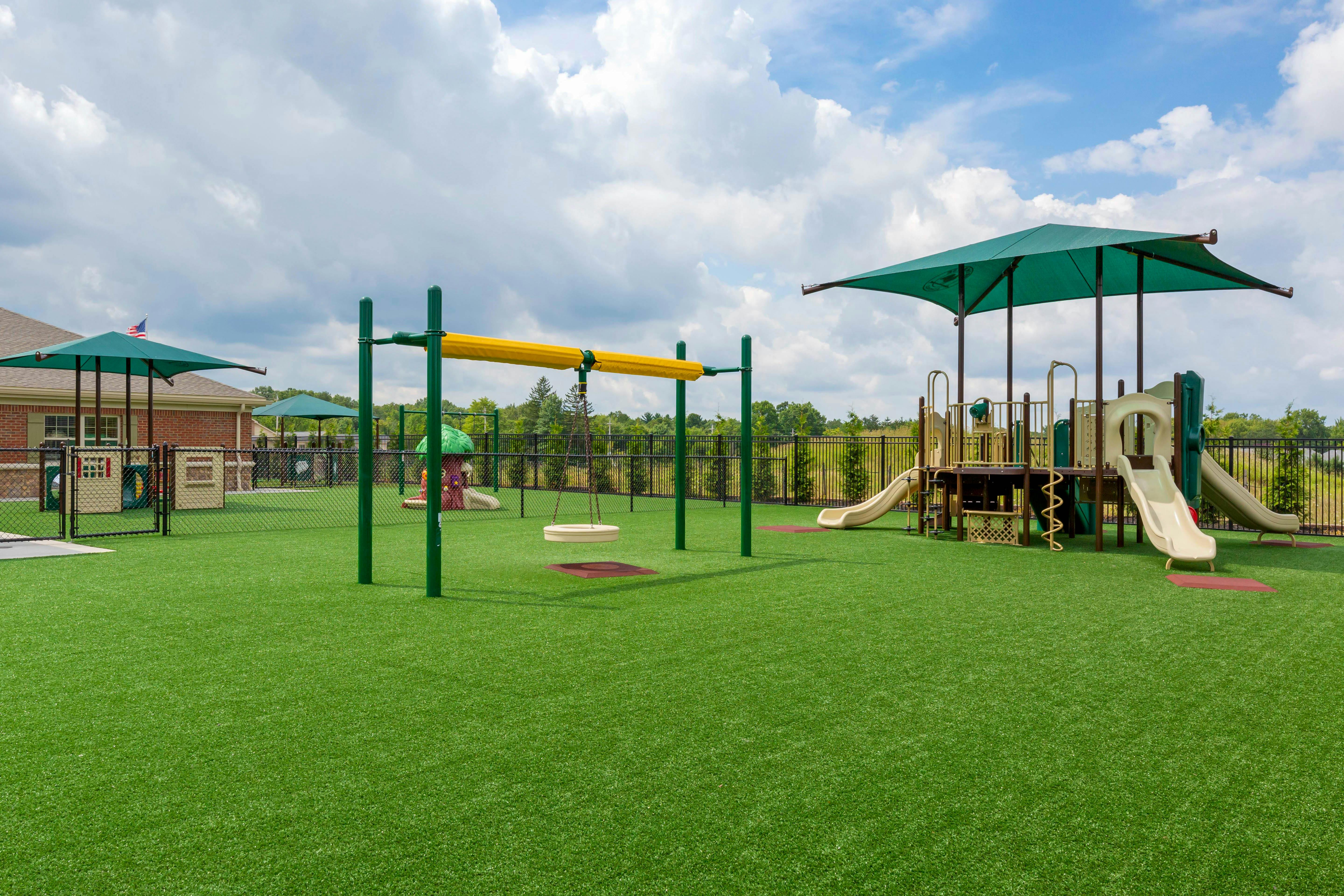 Playground with swings, slides, and turf