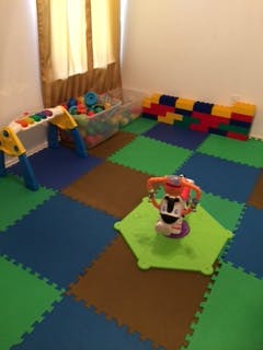 Playroom with colorful floor mats and toys