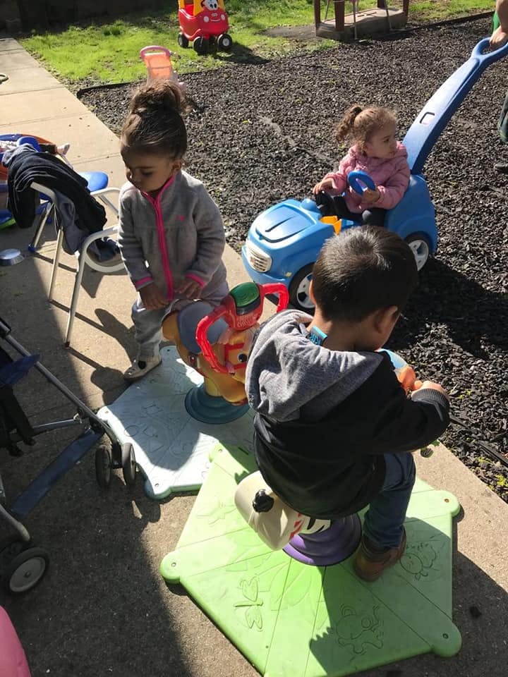 Three children playing with outdoor toys