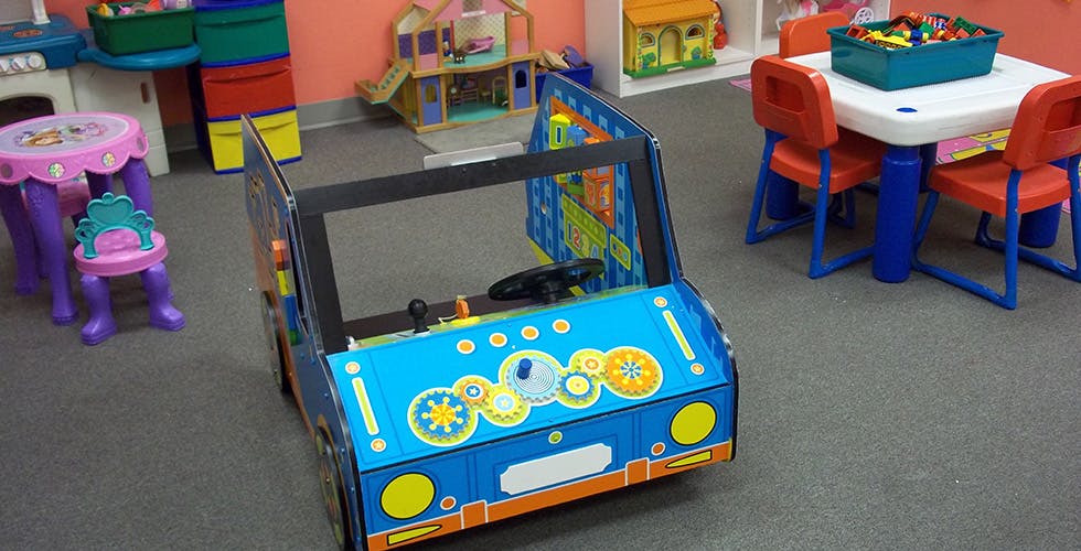 Toy car in a playroom with a small table and chairs