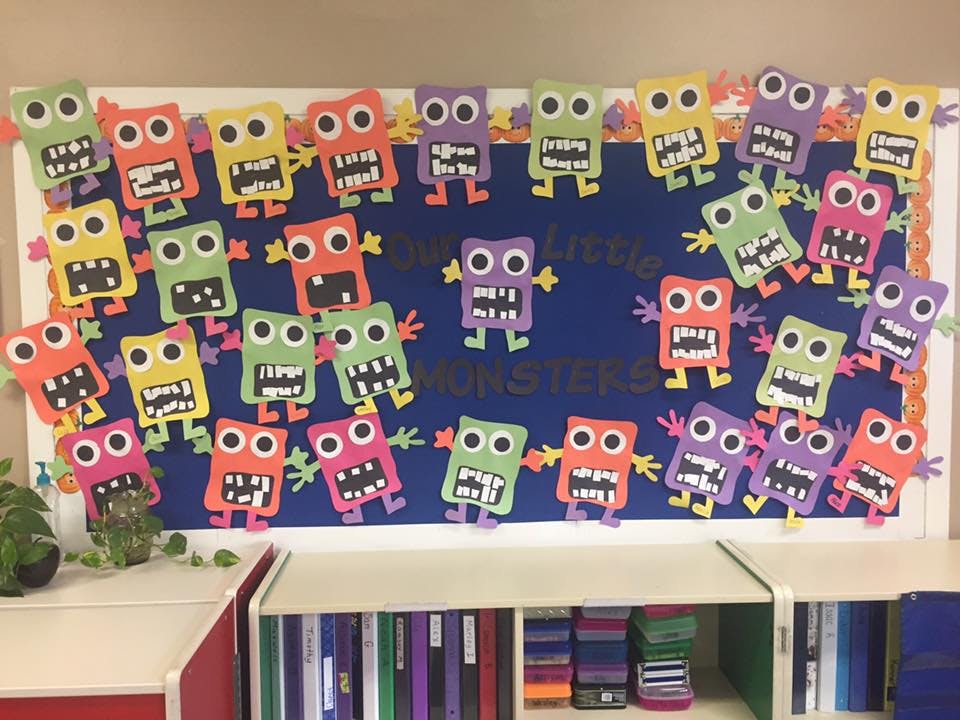 Bulletin board with colorful paper monsters and text "little monsters"