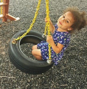 Child on a tire swing