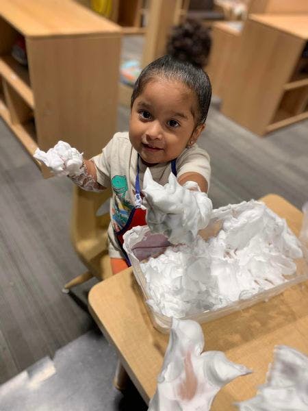 Child playing with shaving cream