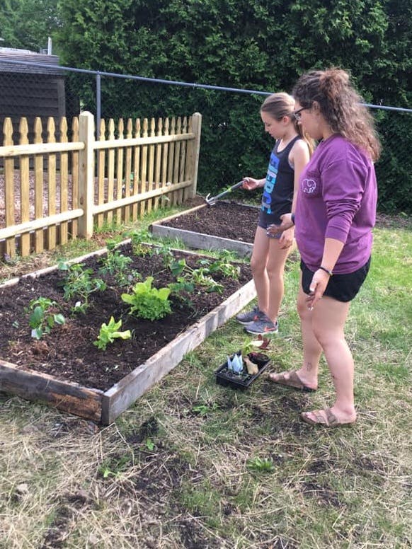Two people gardening in raised beds