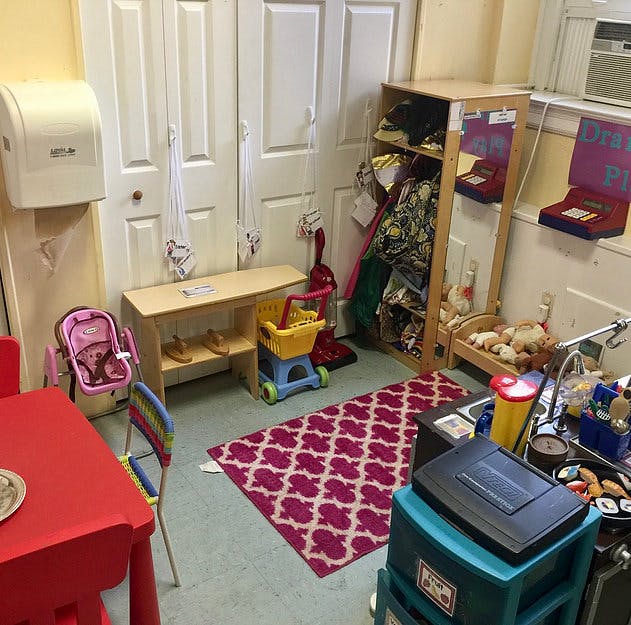 Playroom with small table, chairs, and various toys