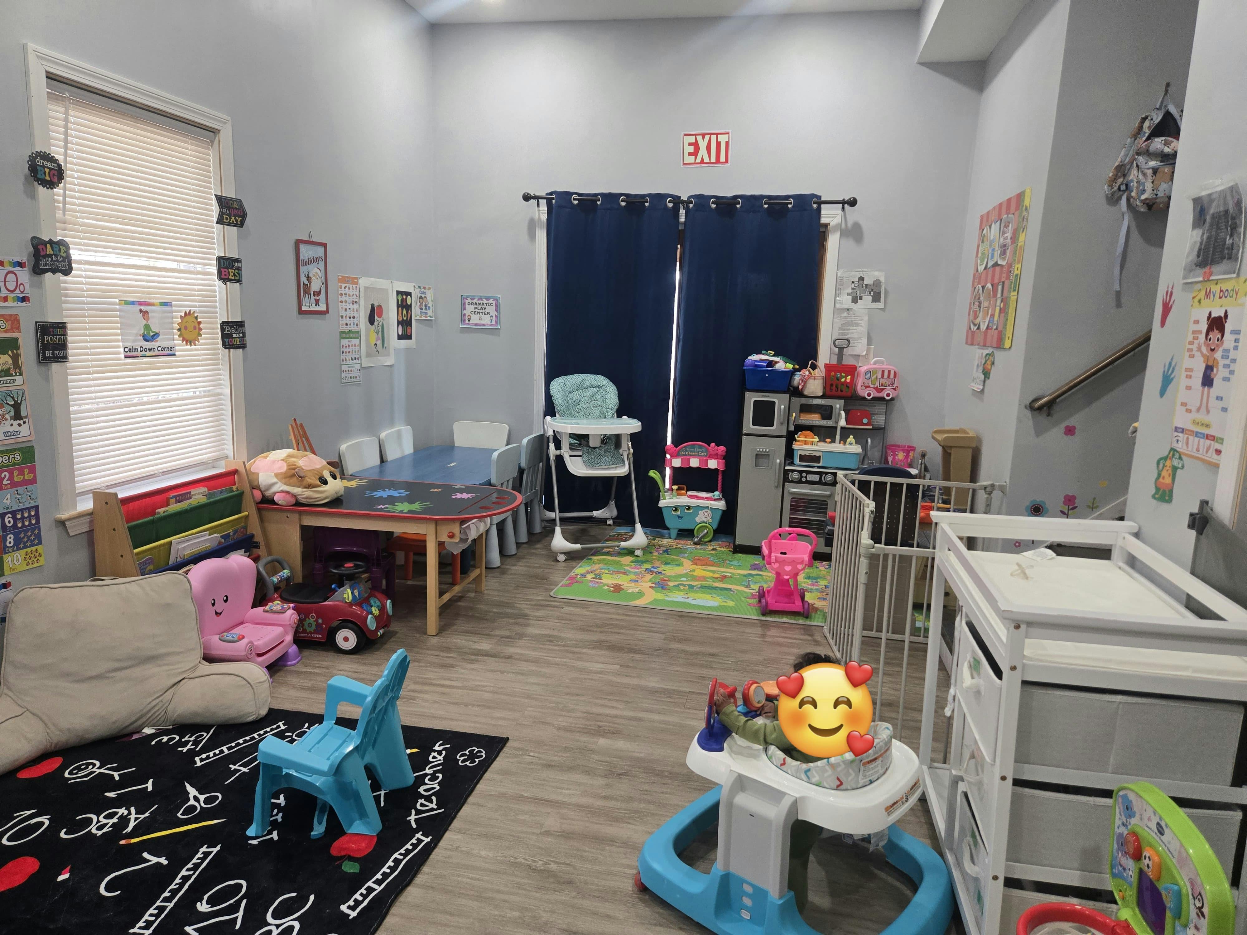 Playroom with various toys, small chairs, and a changing table