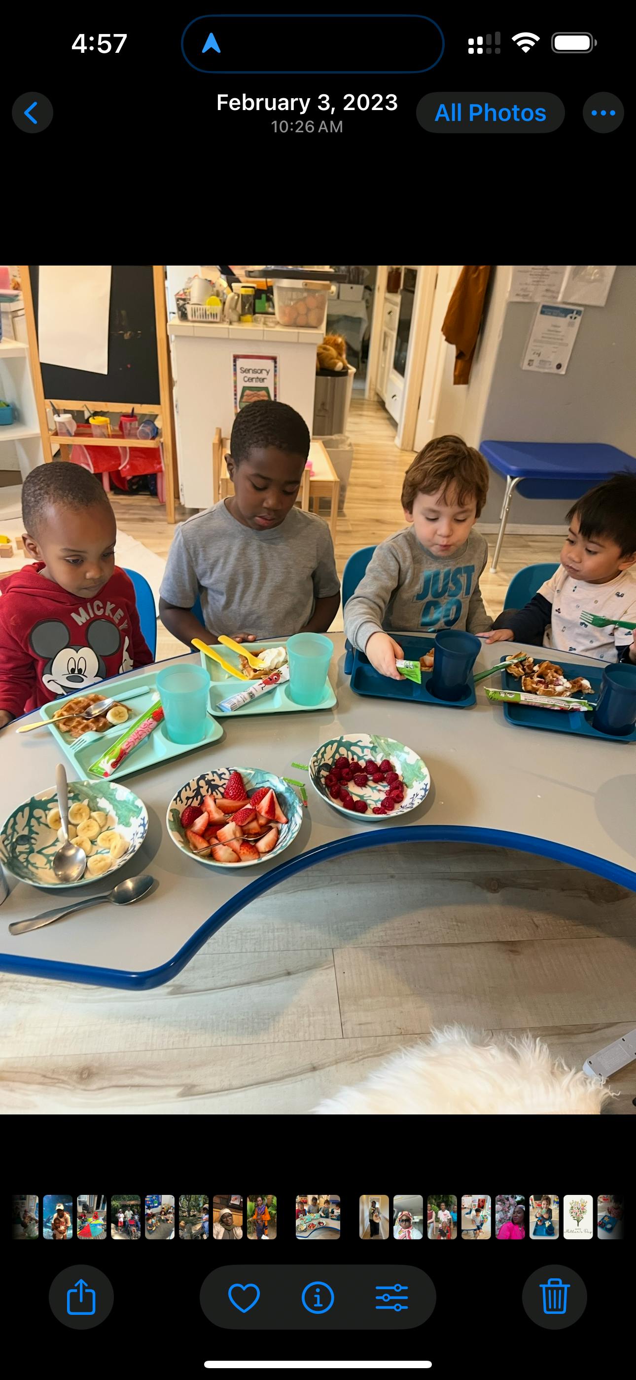 Four children sitting at a table with plates of food