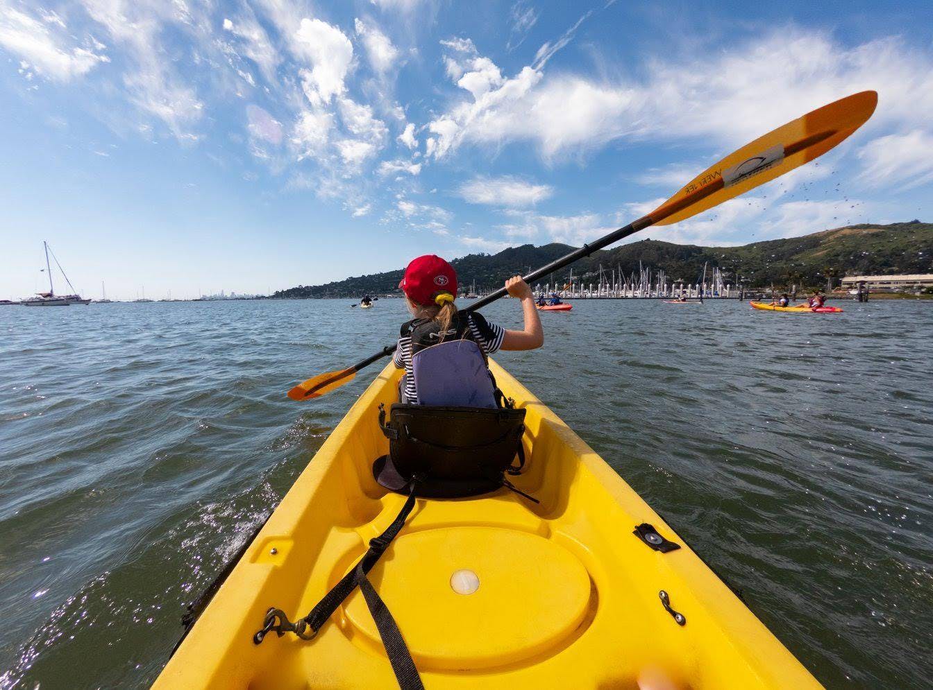 Person in a yellow kayak paddling on water