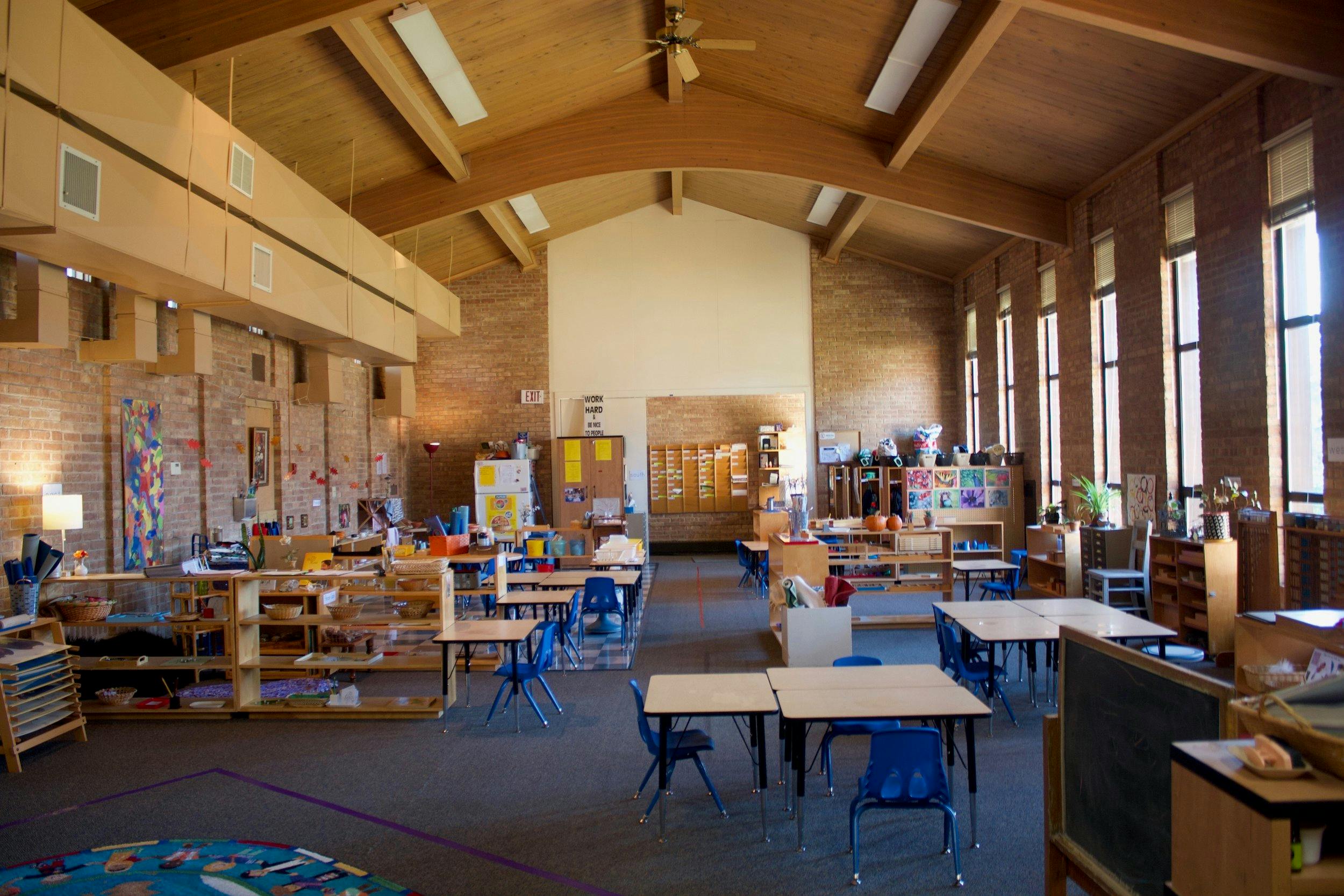 Empty classroom with small tables and chairs